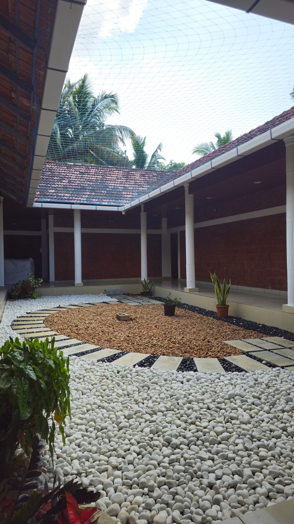Brick courtyard with pebbles and plants