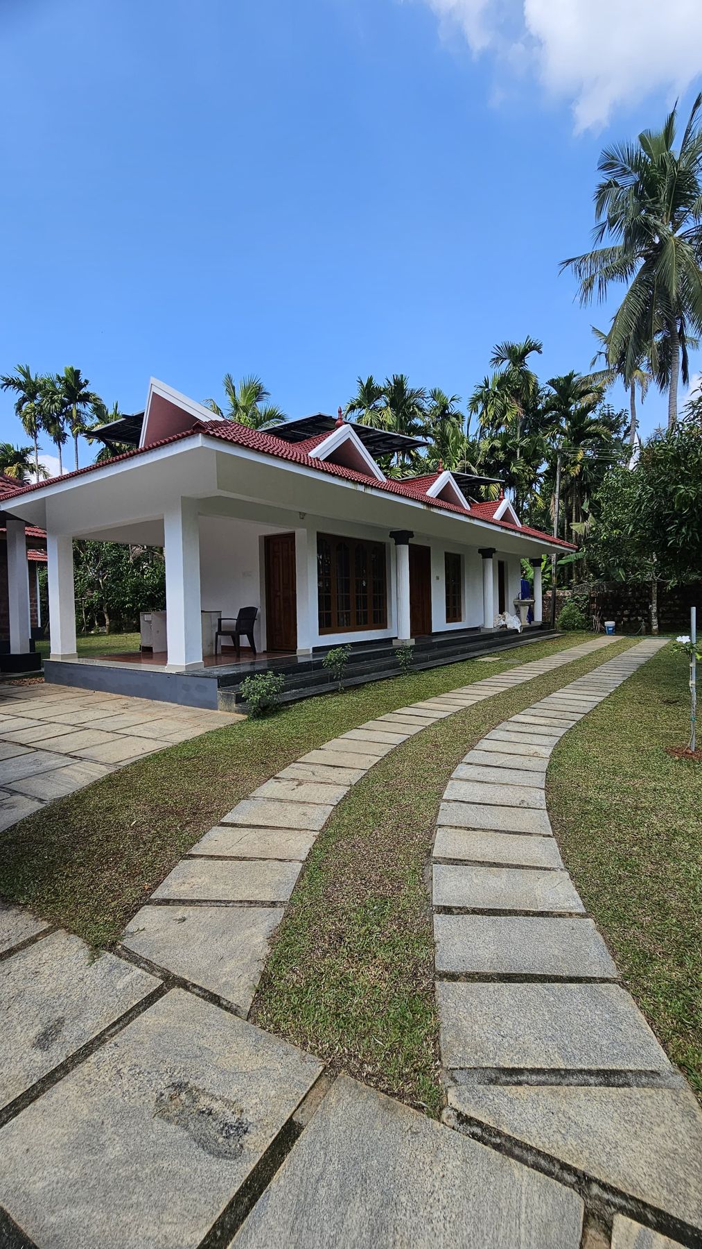 White-pillared veranda with red tiled roof